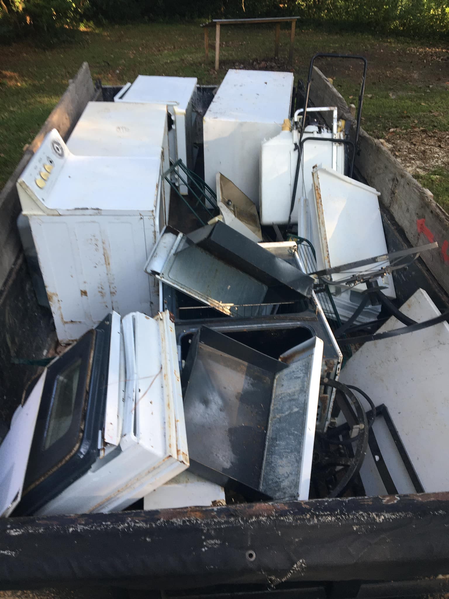 Old appliances and scrap items loaded for junk removal in Mobile, Alabama